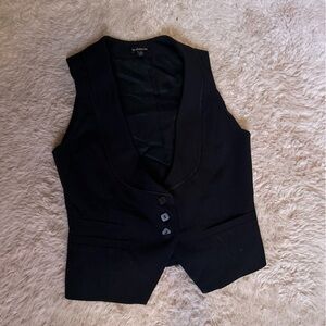 Classic black vest. Satin ribbon tailoring. Three buttons and tie at back.